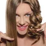 Woman with haircut keeps hair in hands