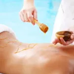 Spa Treatment - woman undergoing spa treatment with honey.
