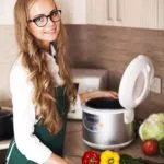 beautiful girl in the kitchen with slo-cooker